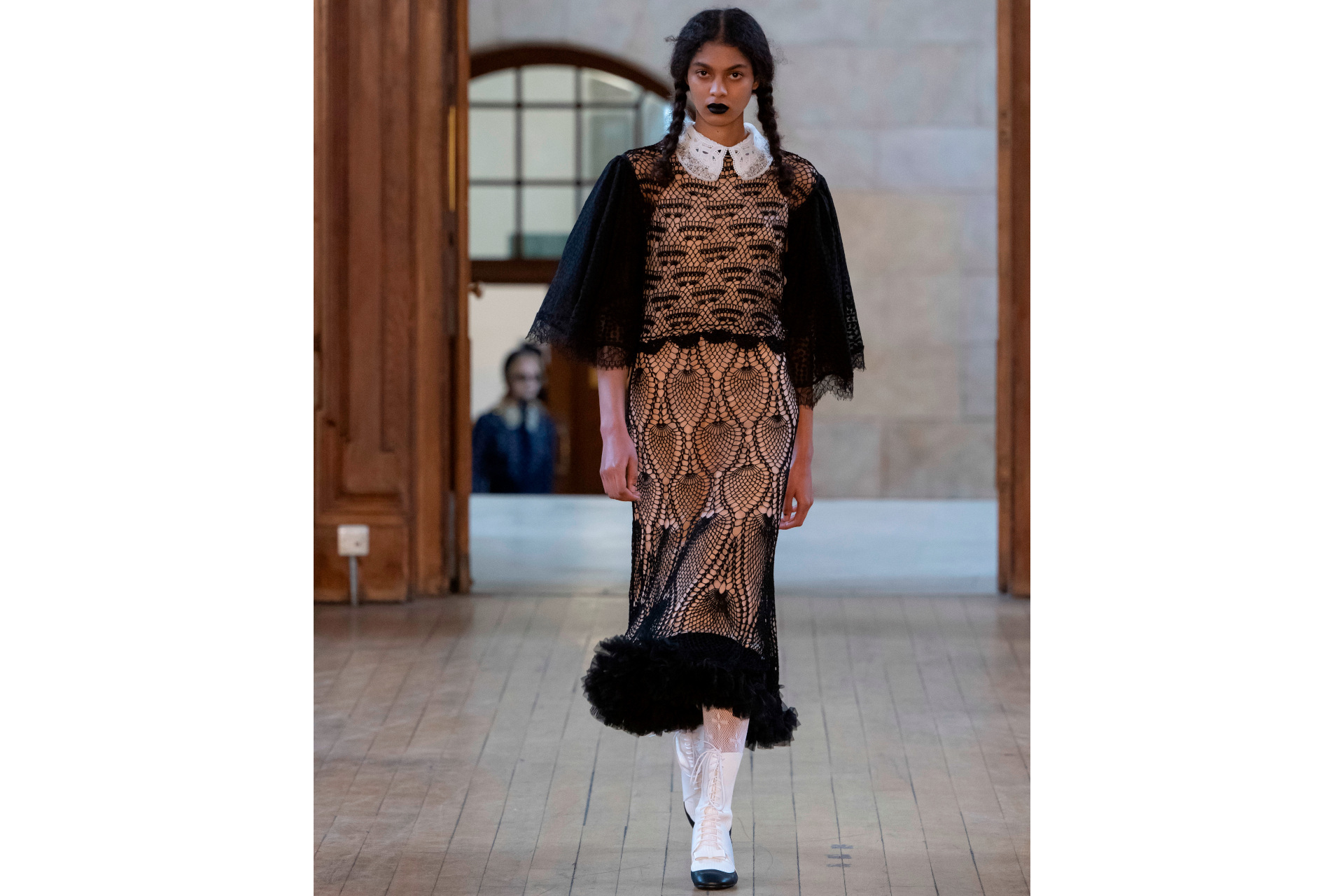 Woman in black and beige pattern dress