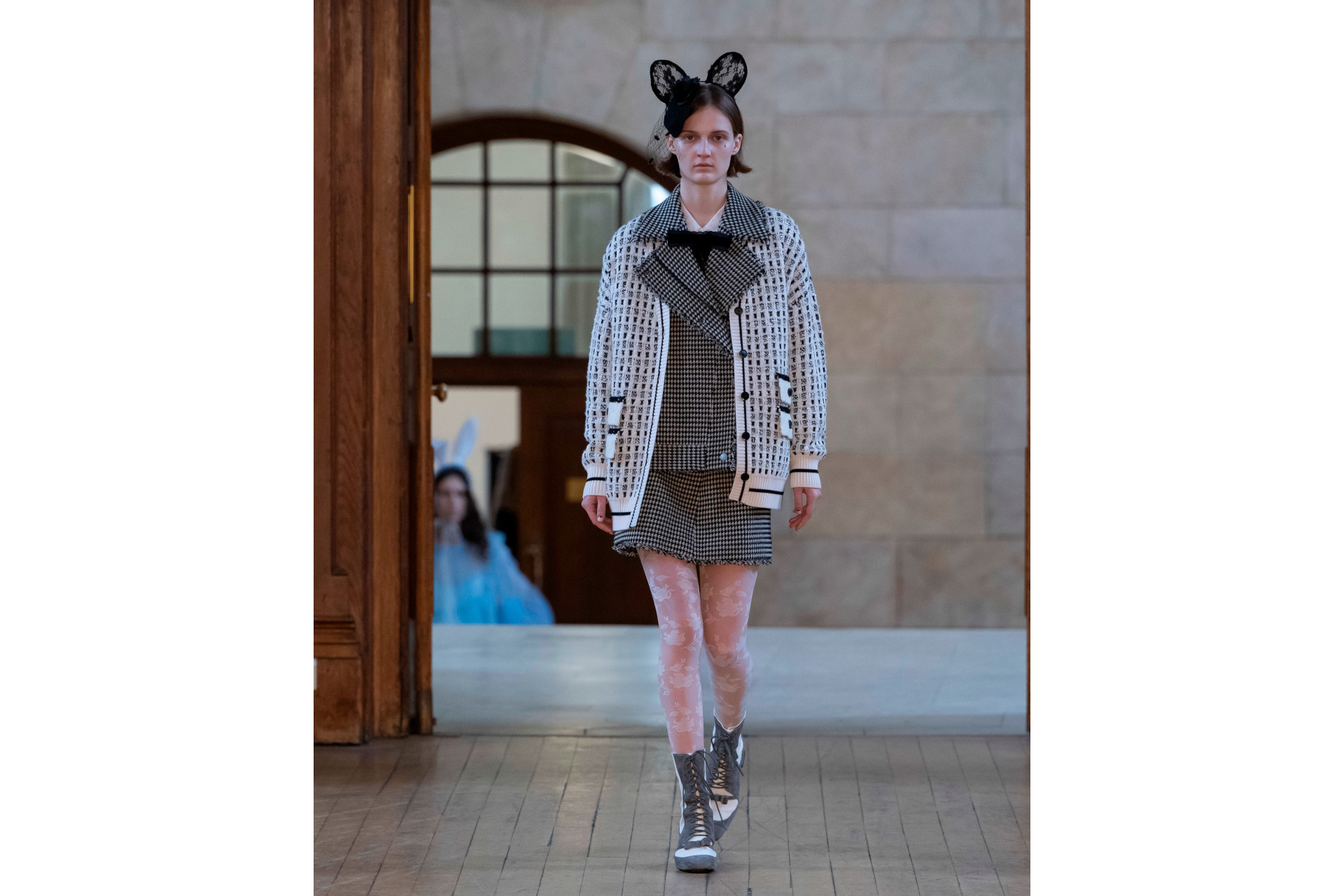 Woman in grey clothes with black bunny ears