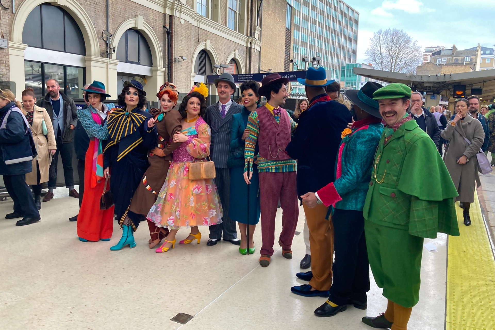 People in costume lined up on train platform