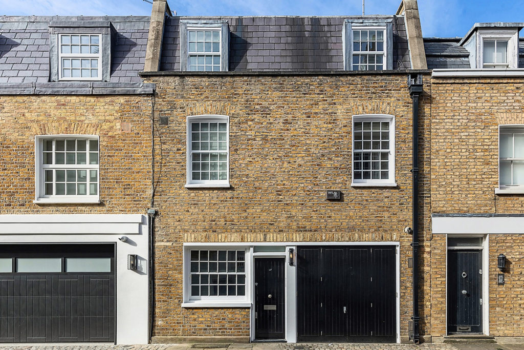 House in Cadogan Lane, Belgravia, with brick exterior and black wooden doors.