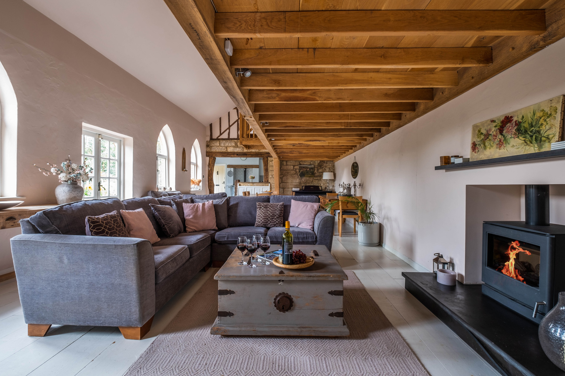 A spacious living room with wood beam ceilings