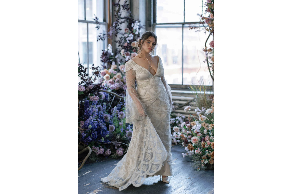 Woman in white long-sleeve gown with beaded embellishments
