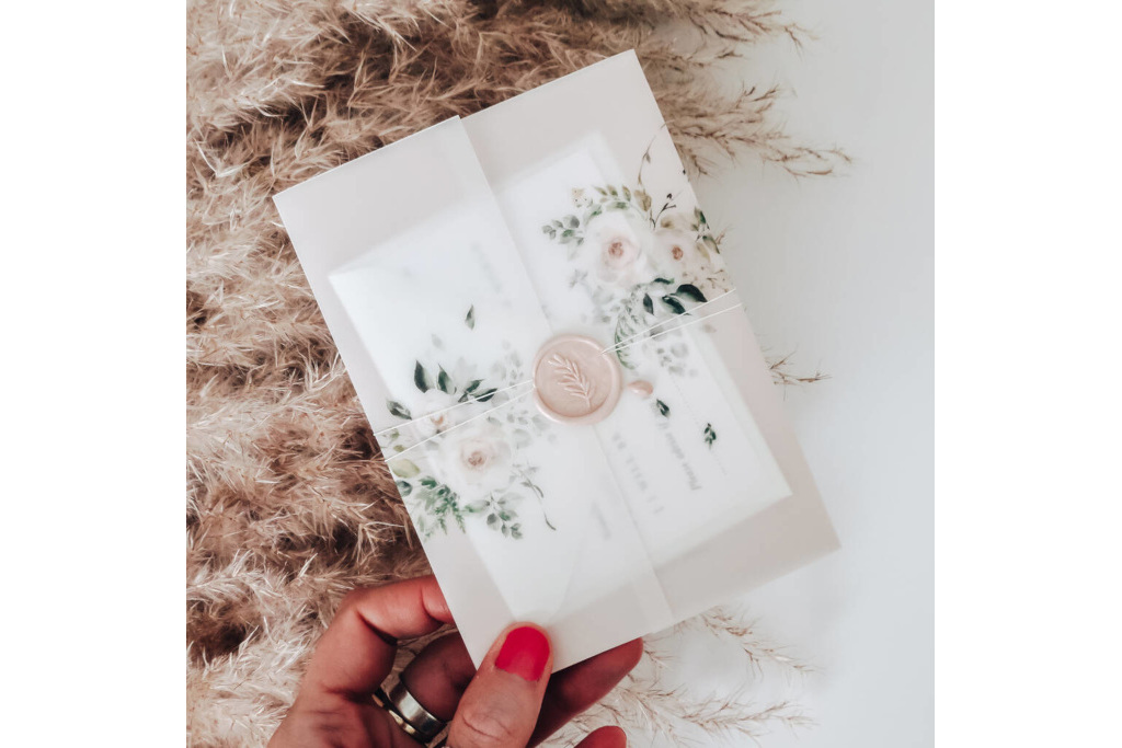 Hand holding wedding invitation