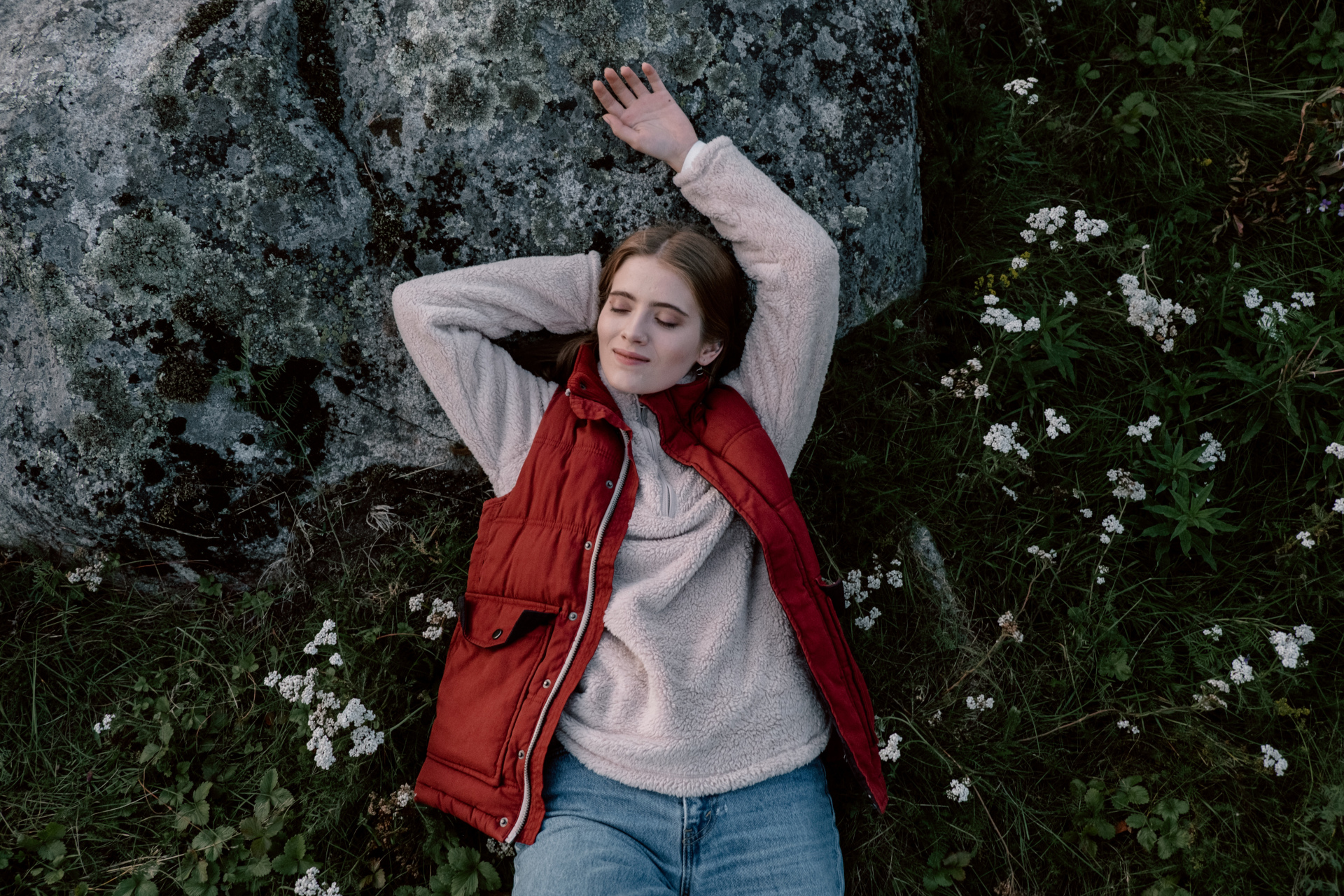 Woman leaning back on rocks