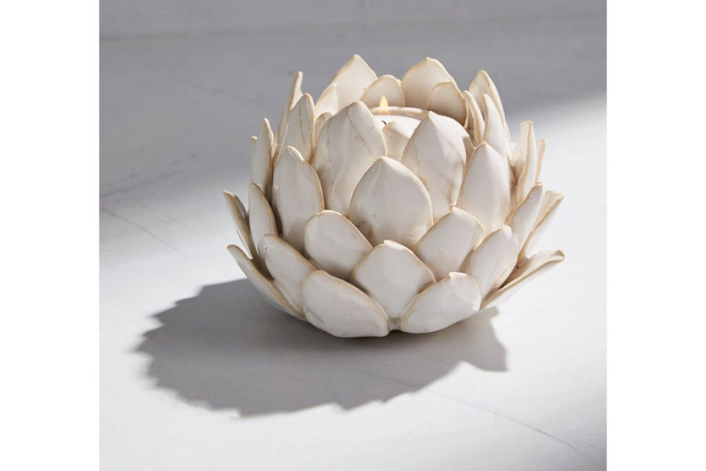 White candle holder in the shape of an artichoke.