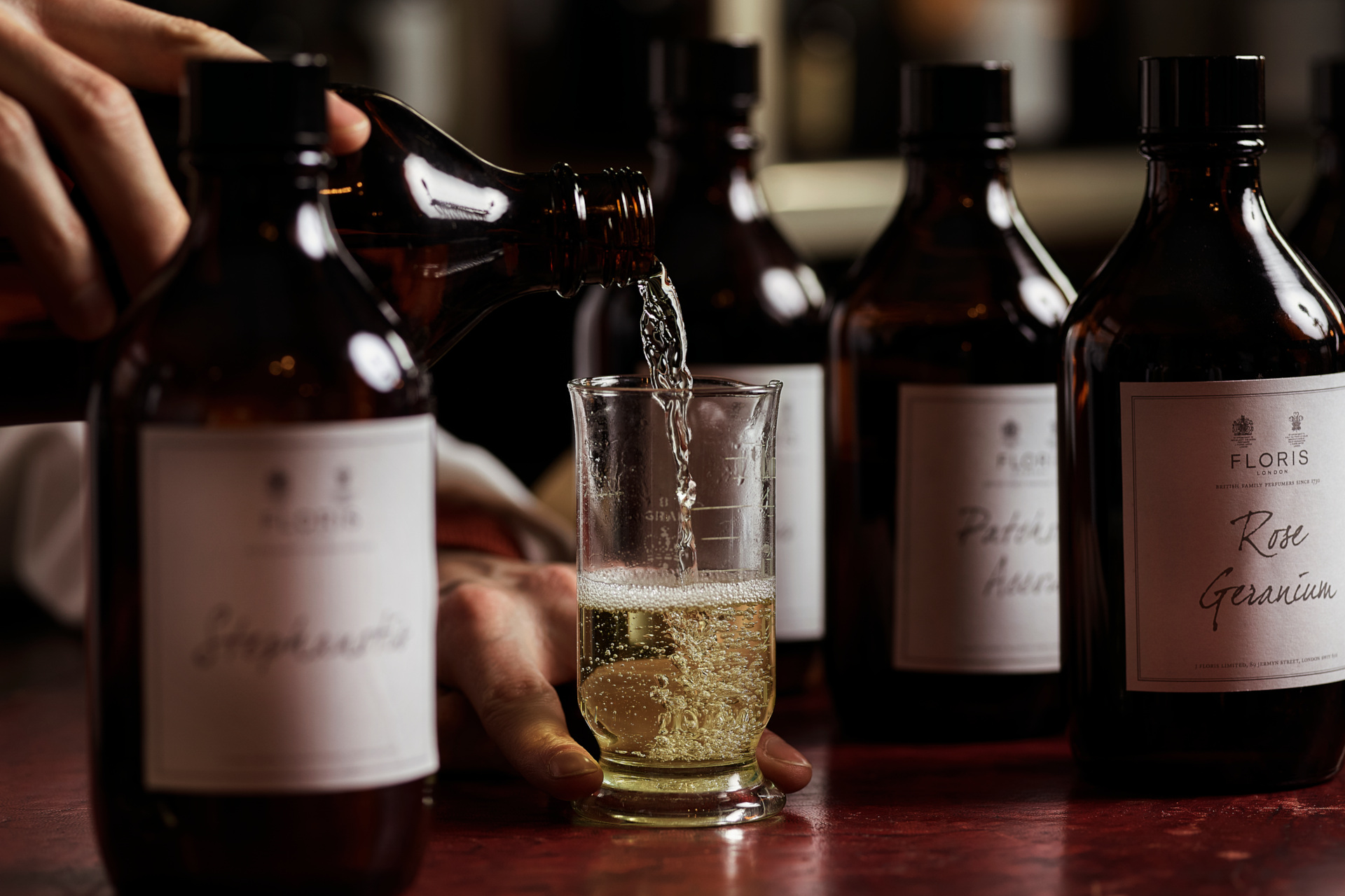 Close up of perfumes being poured into bottles