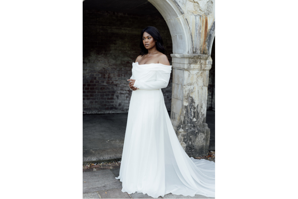 Black woman in white long sleeve dress