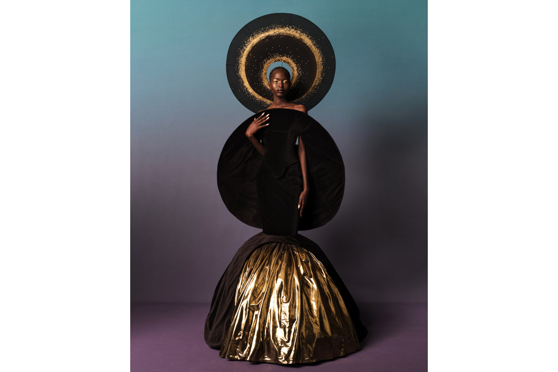 Black model in black and gold circular fashion sculpture