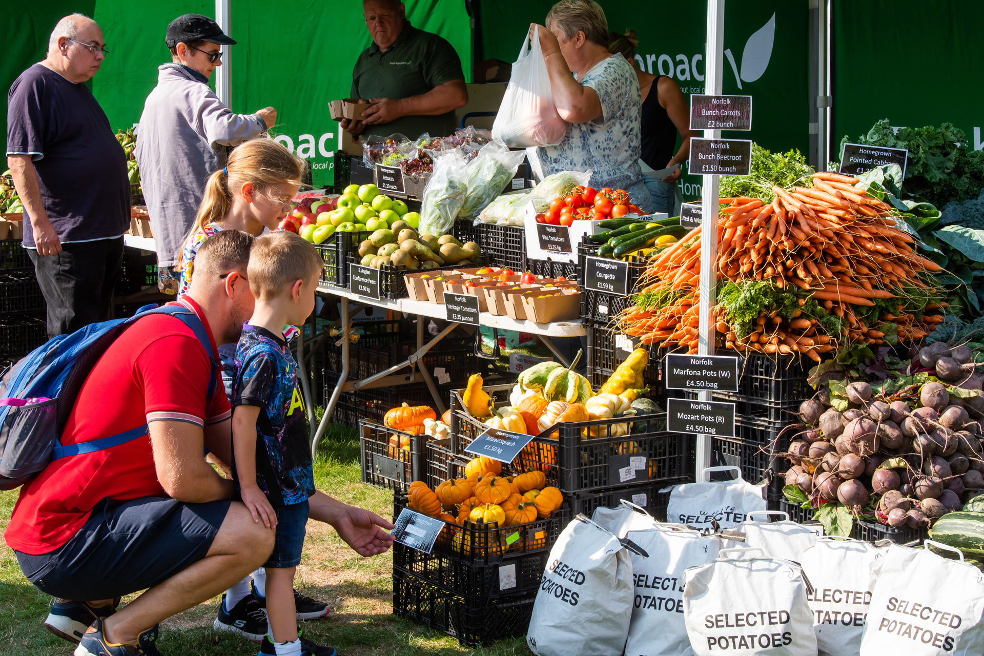 Dad and son looking at food at Norfolk Food Festival