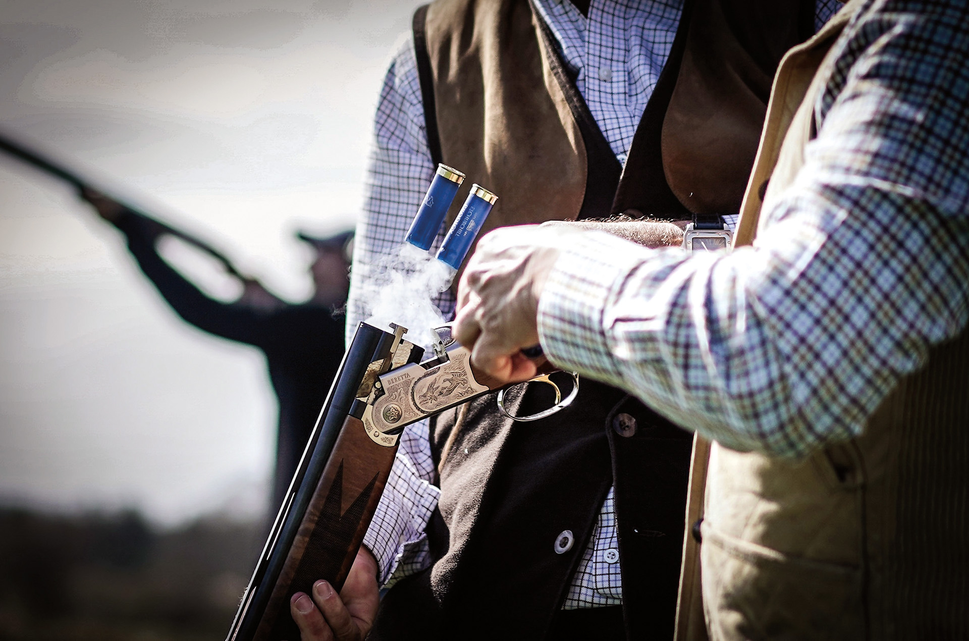 Two people handling a gun