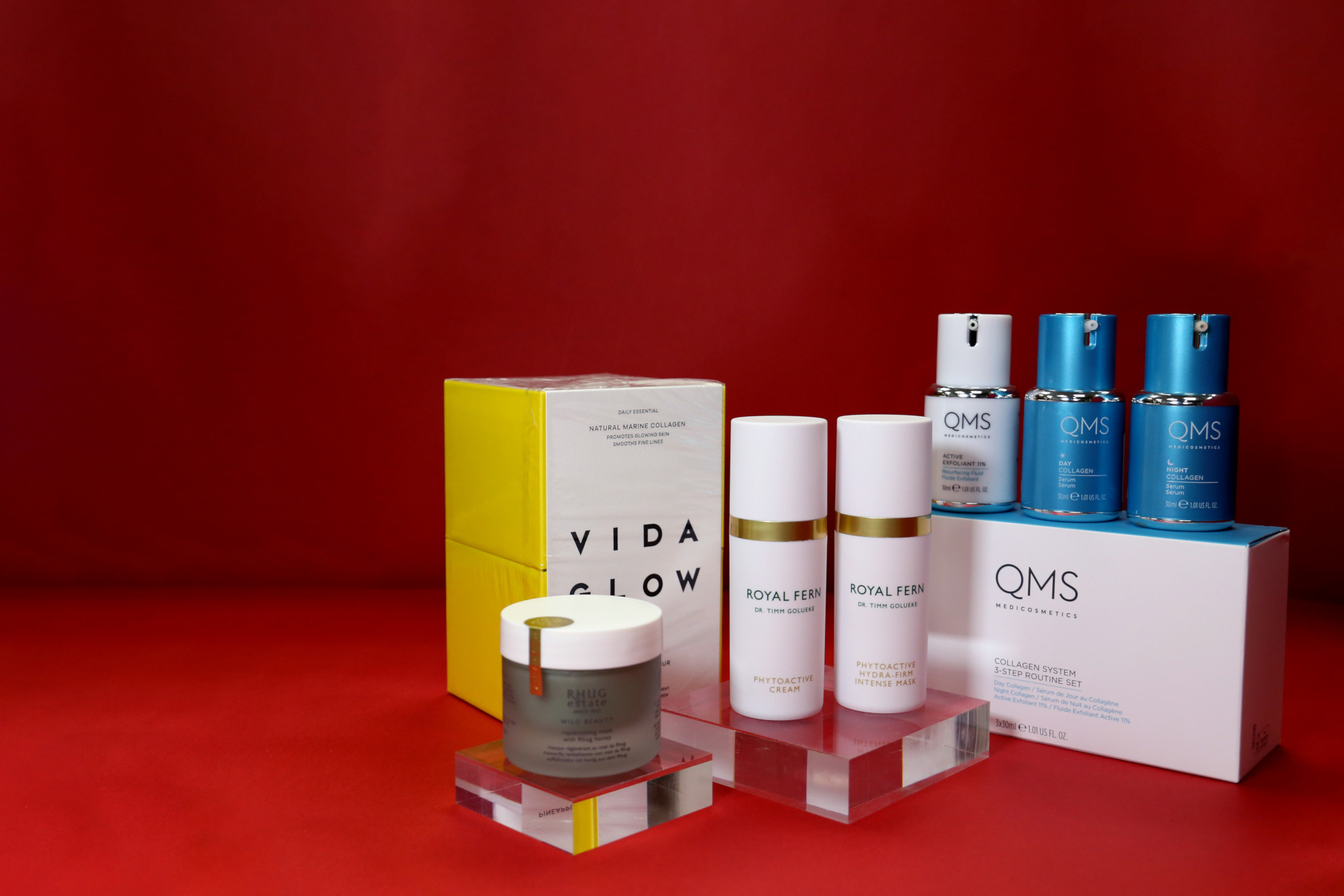 Skincare products set in front of red background