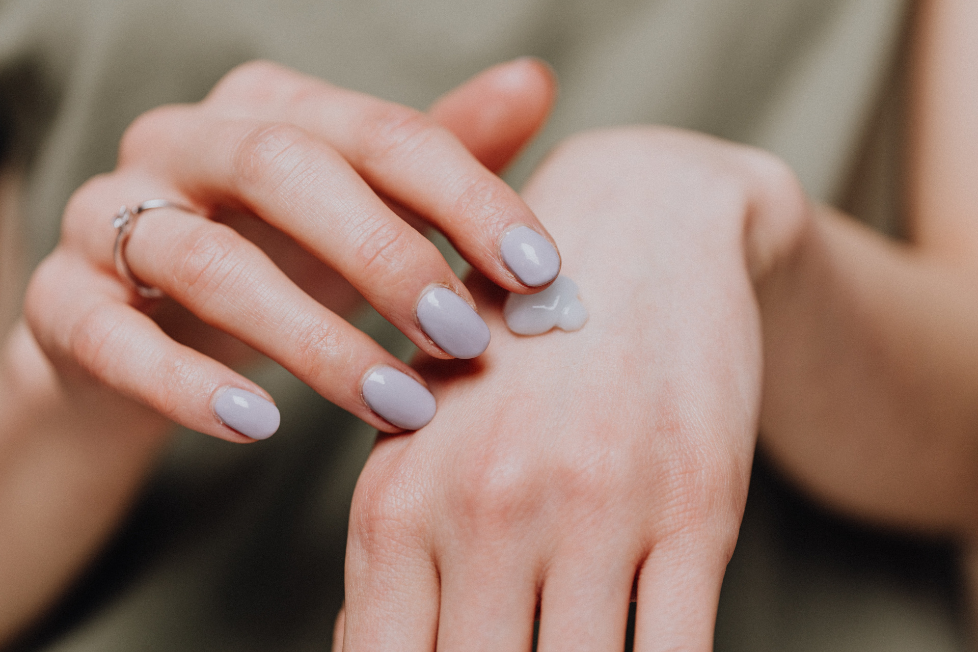 Close up of hands with cream on the back of them