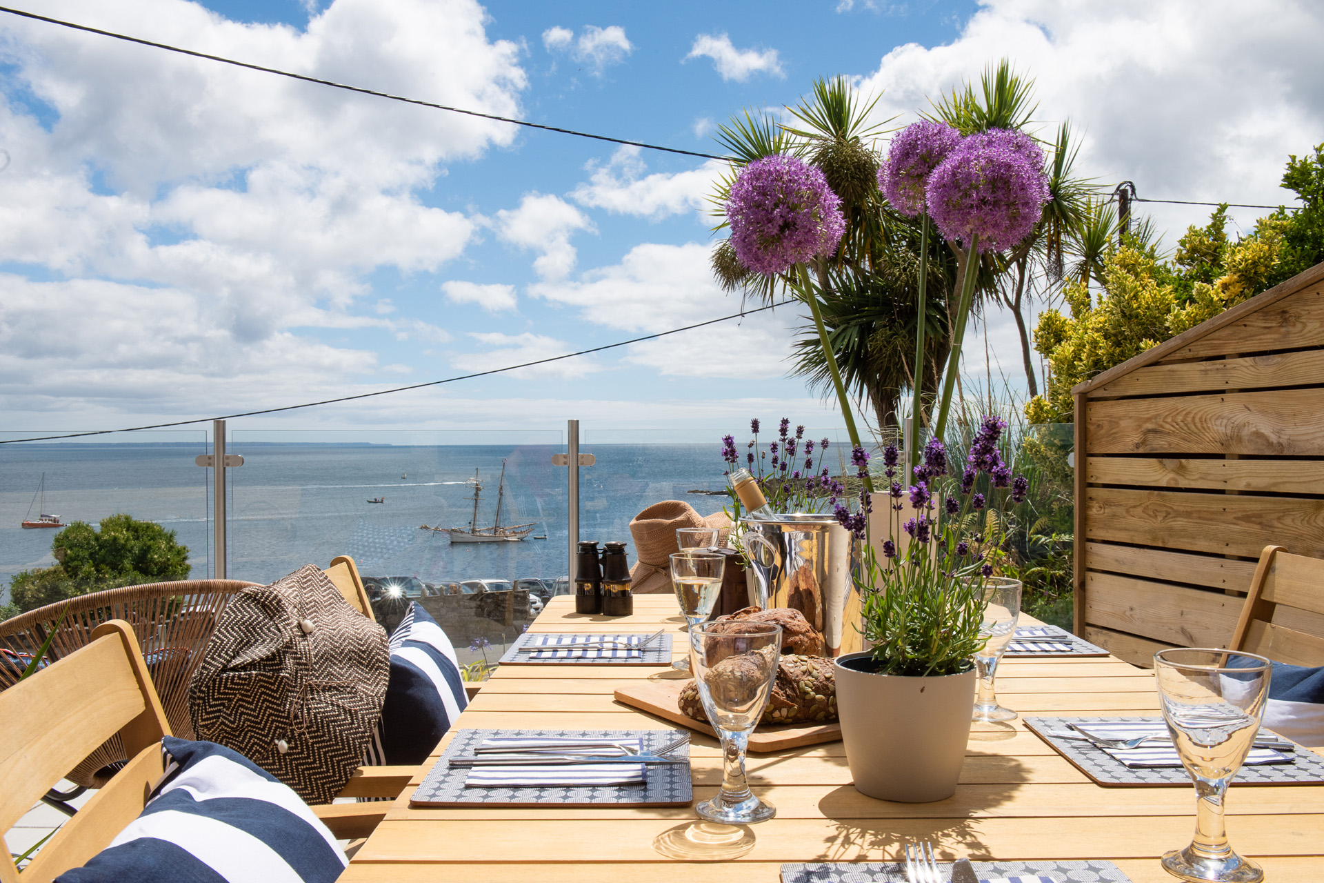 An al fresco dinner table overlooking the sea