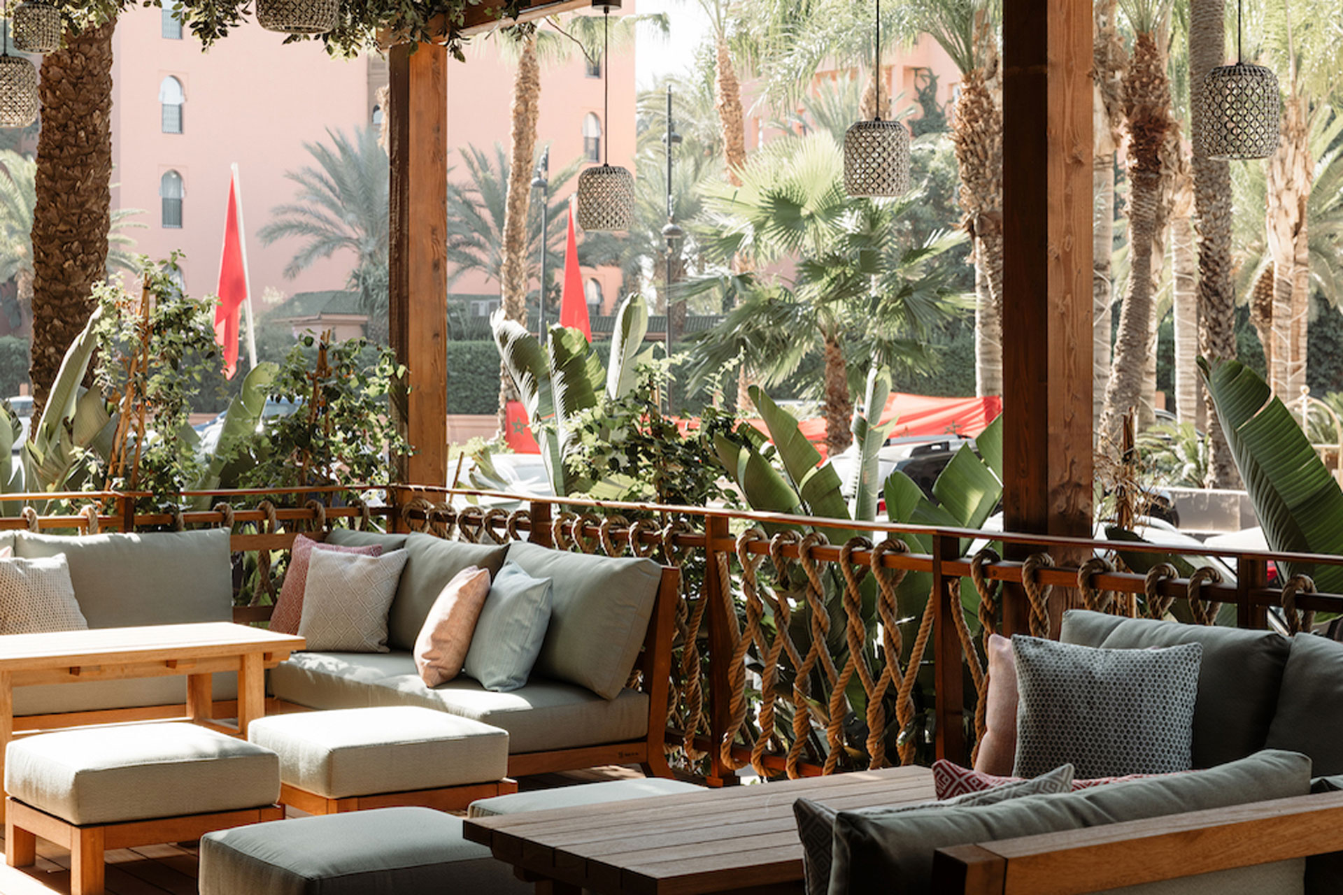 Outdoor restaurant at Nobu Hotel Marrakech, with outdoor seating and palm fronds.