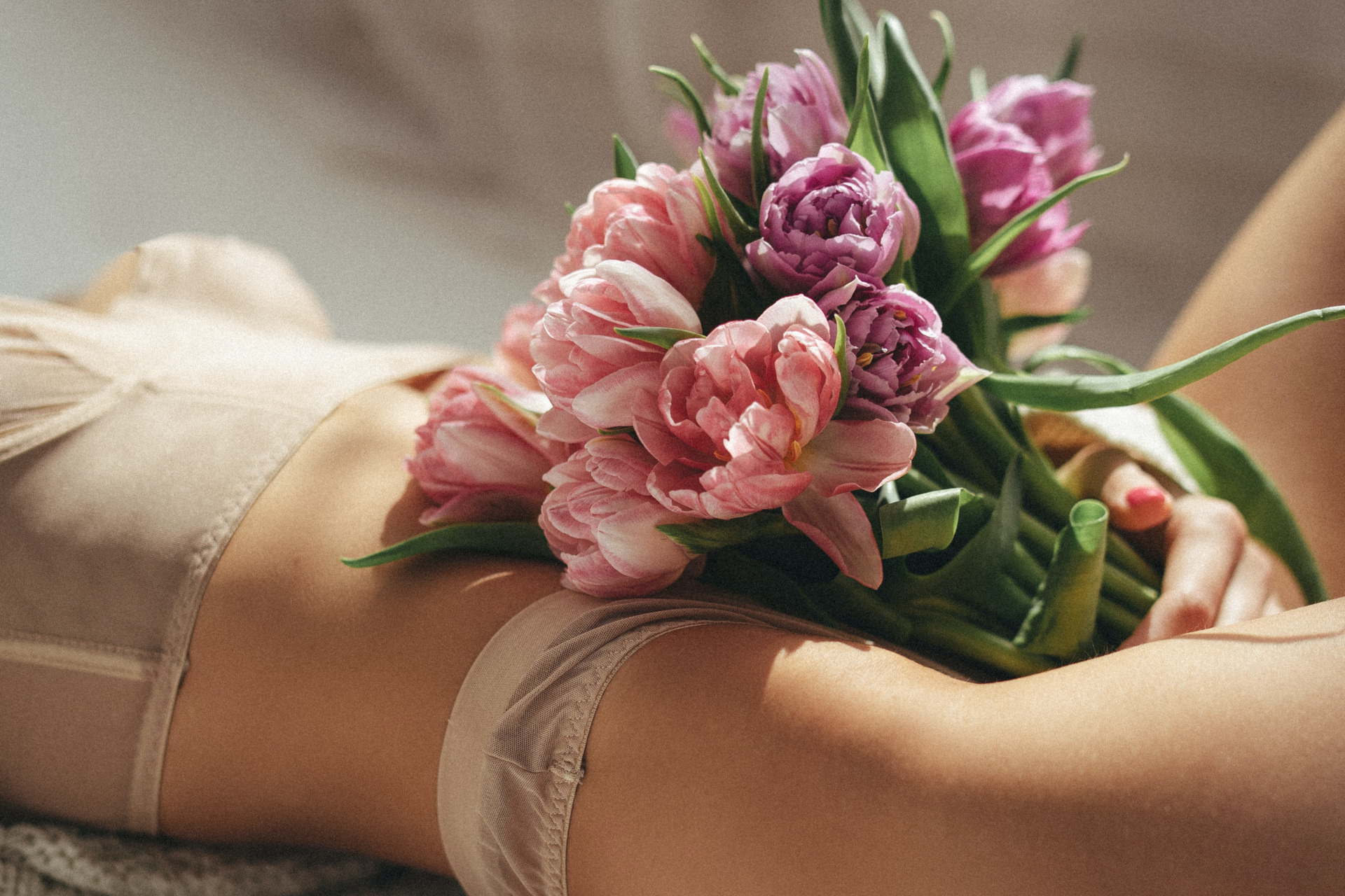 Woman in lingerie with bouquet of flowers