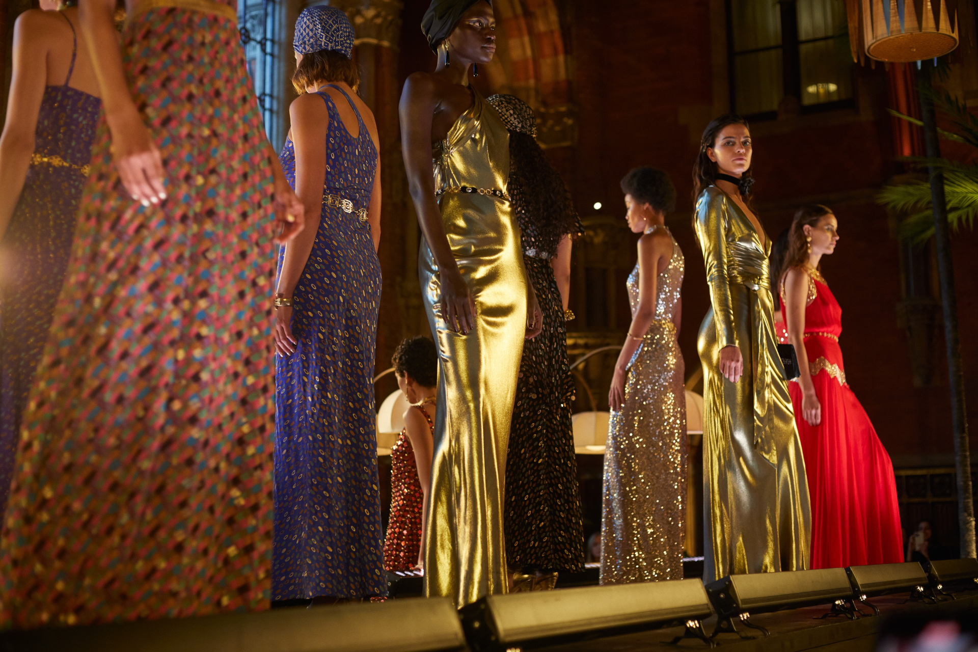 Models stood on platform in eveningwear