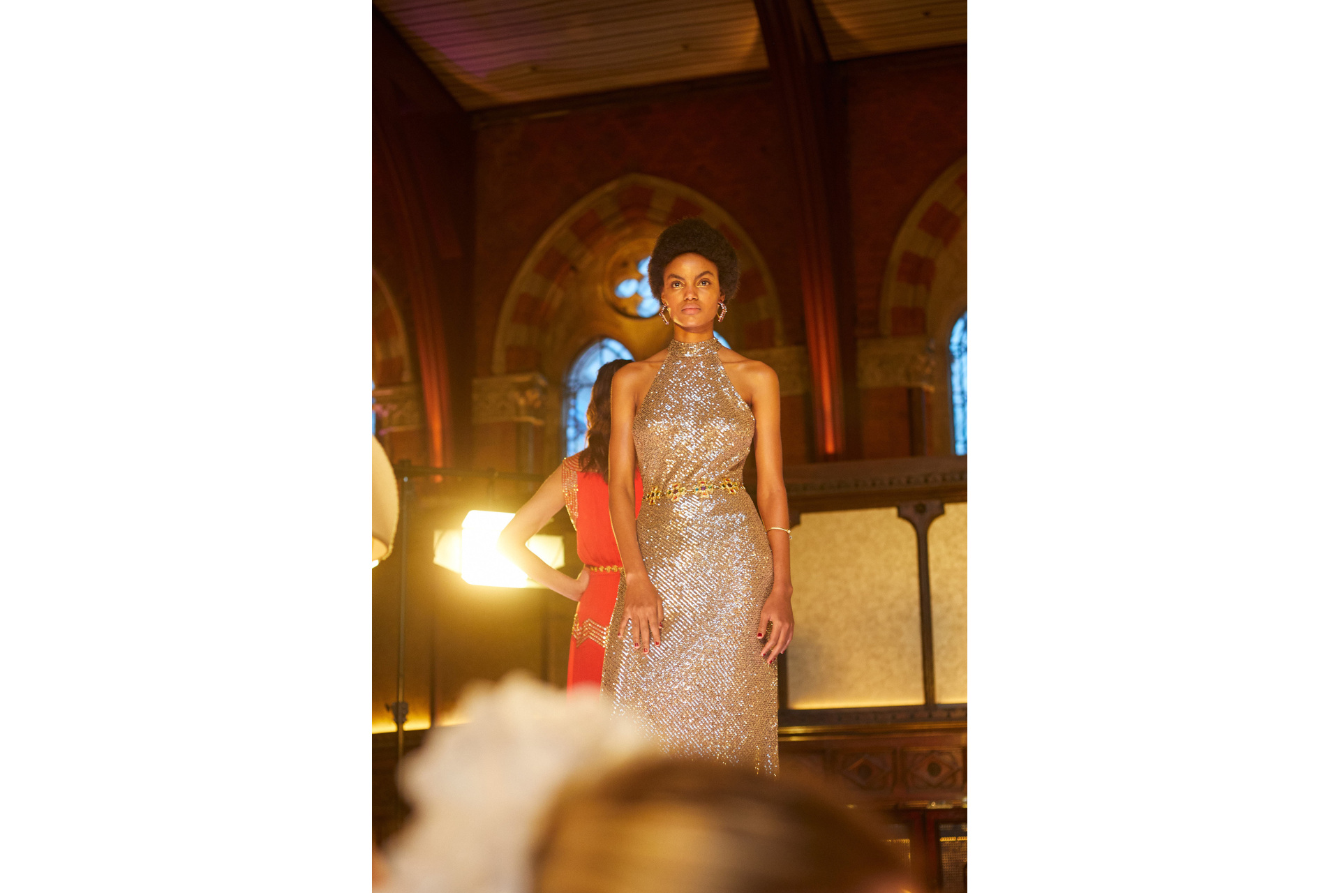 Models in evening gowns stood on raised platform