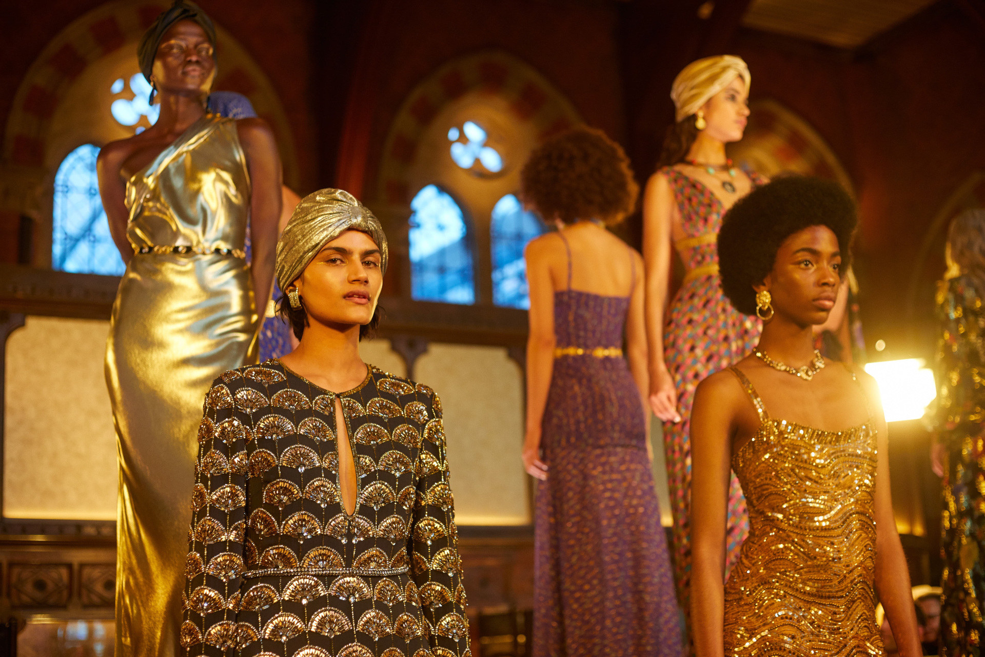 Models in evening gowns stood on raised tiered platforms