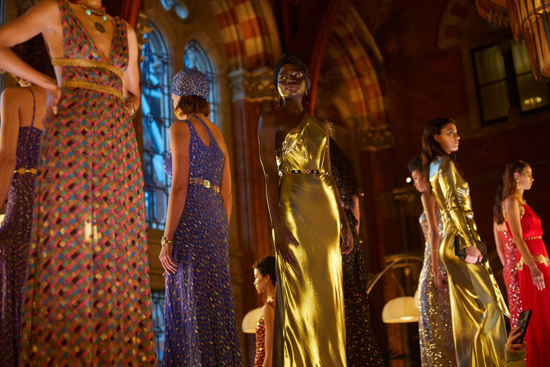 Models in evening gowns stood on raised platform in bar