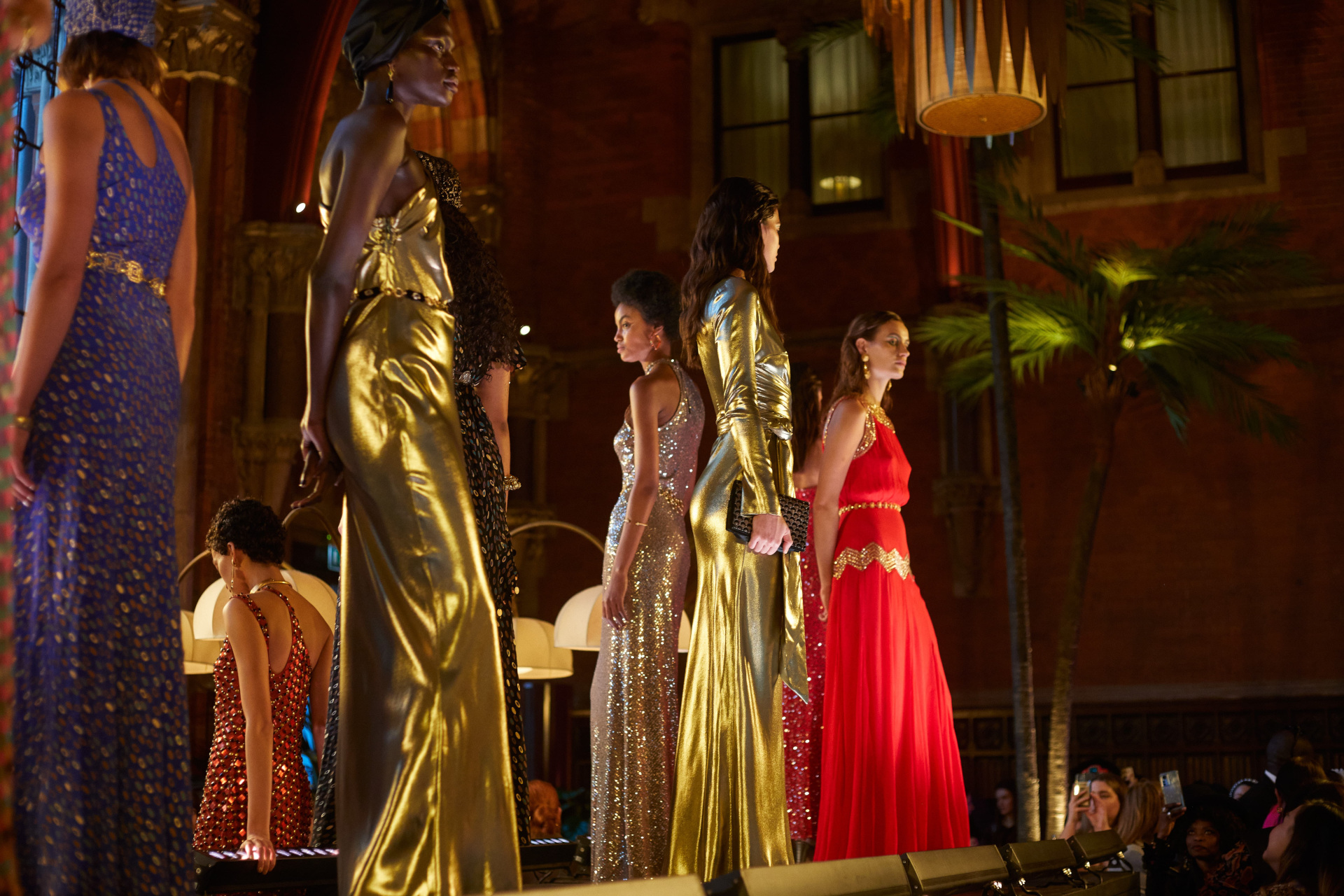 Models in evening gowns stood on raised platform in bar