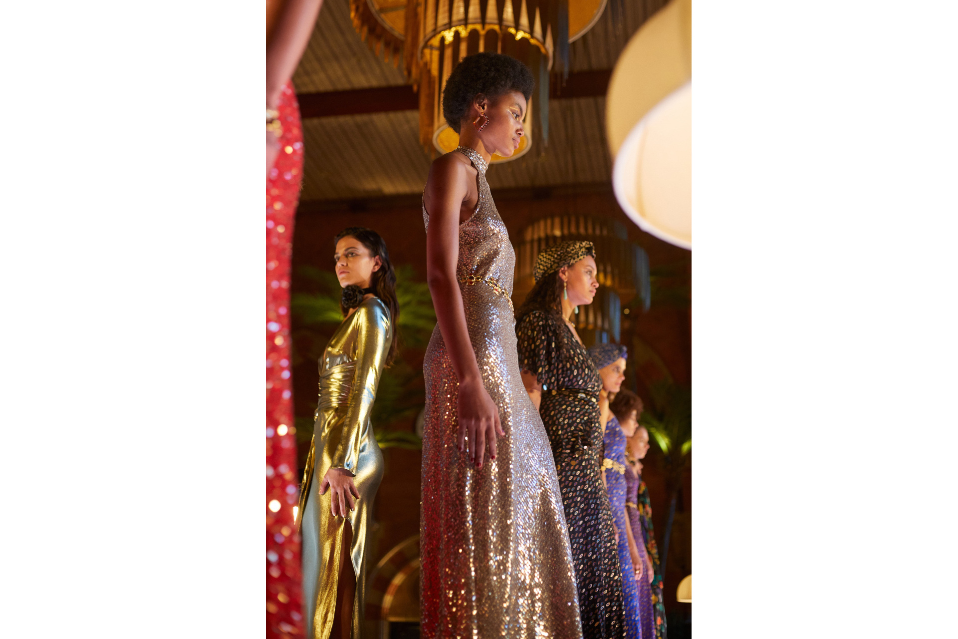 Models in evening gowns stood on raised platform in bar