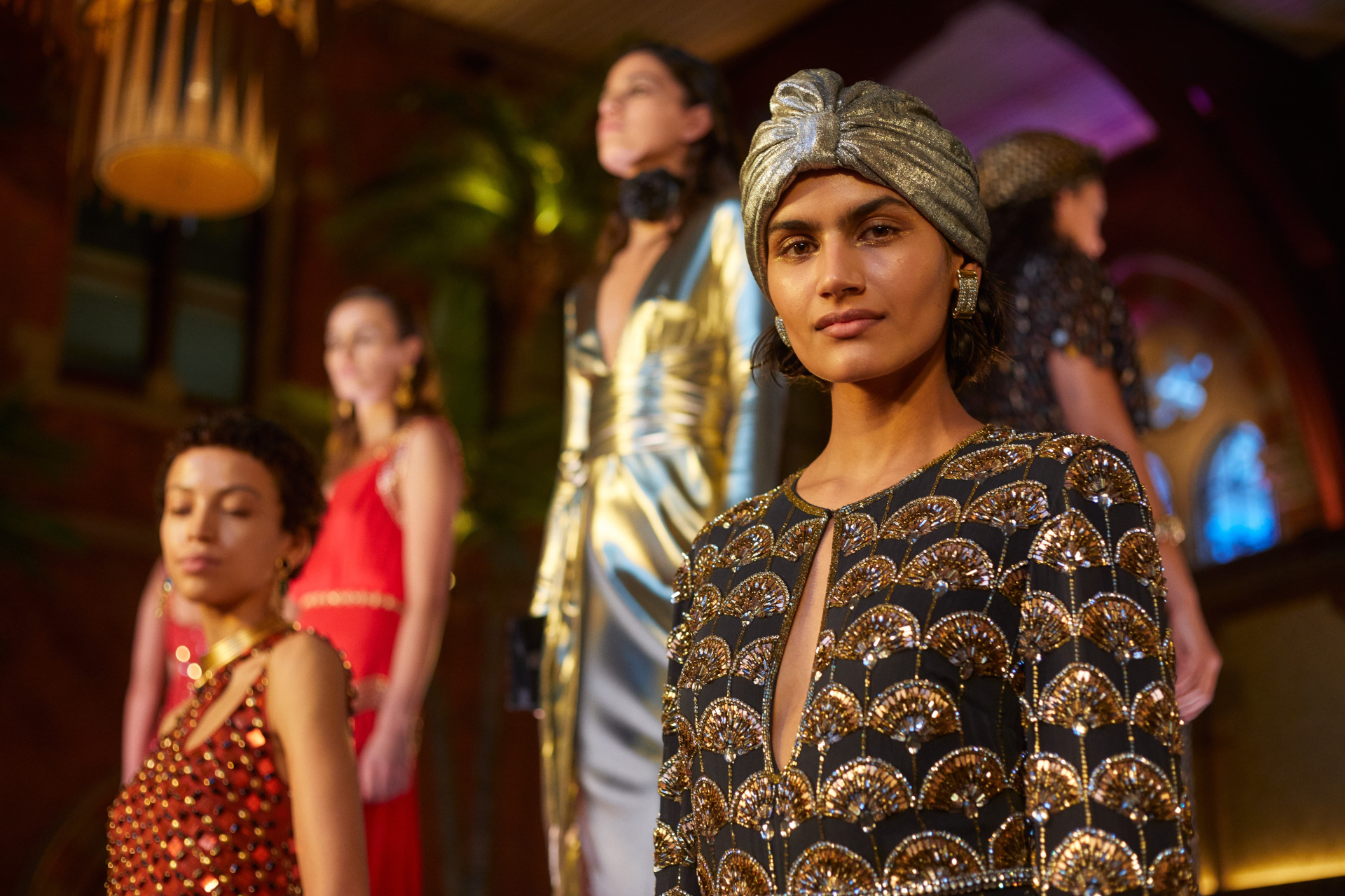Models in evening dresses looking forward