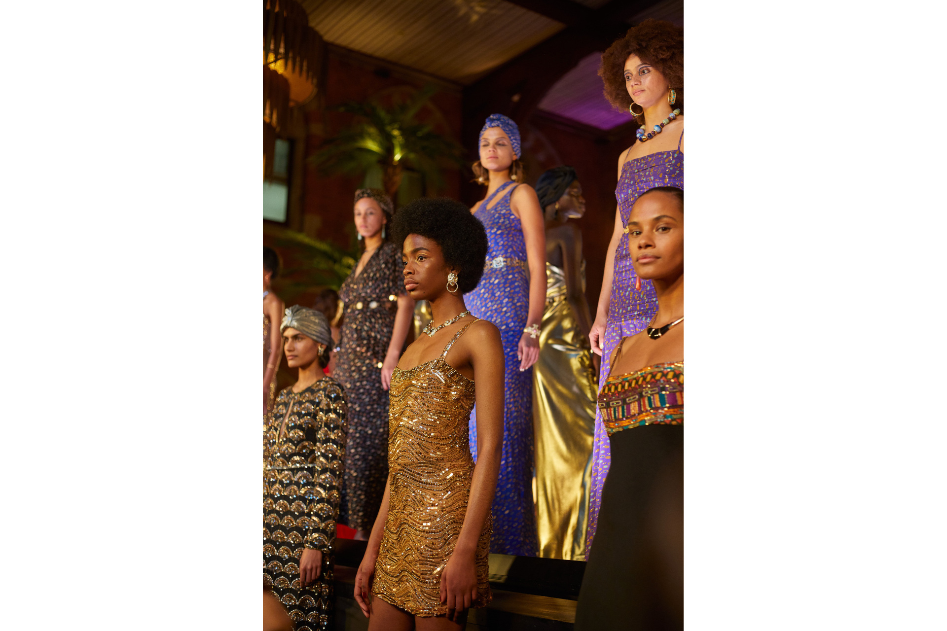 Models in evening gowns stood on raised tiered platform