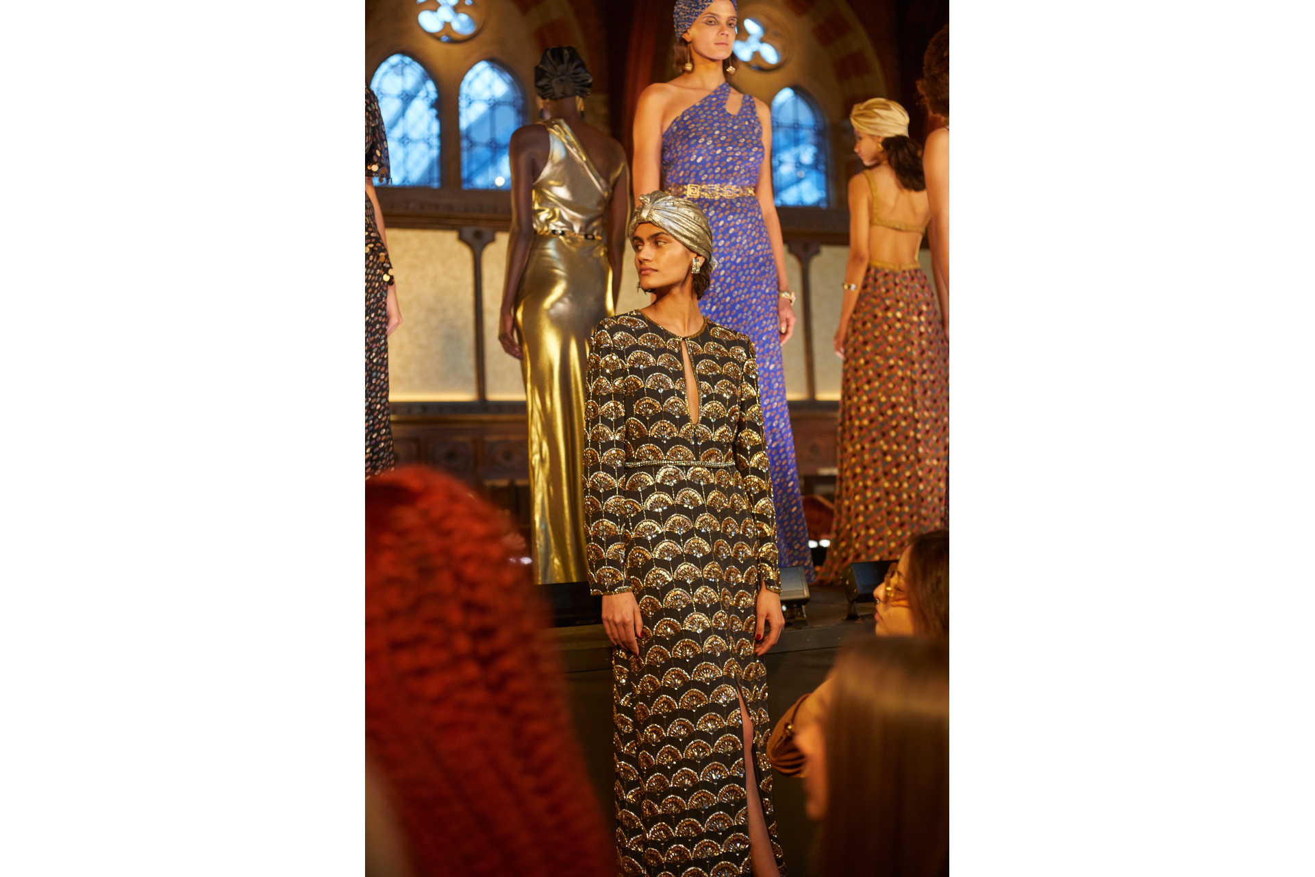 Models in evening gowns stood on raised tiered platform