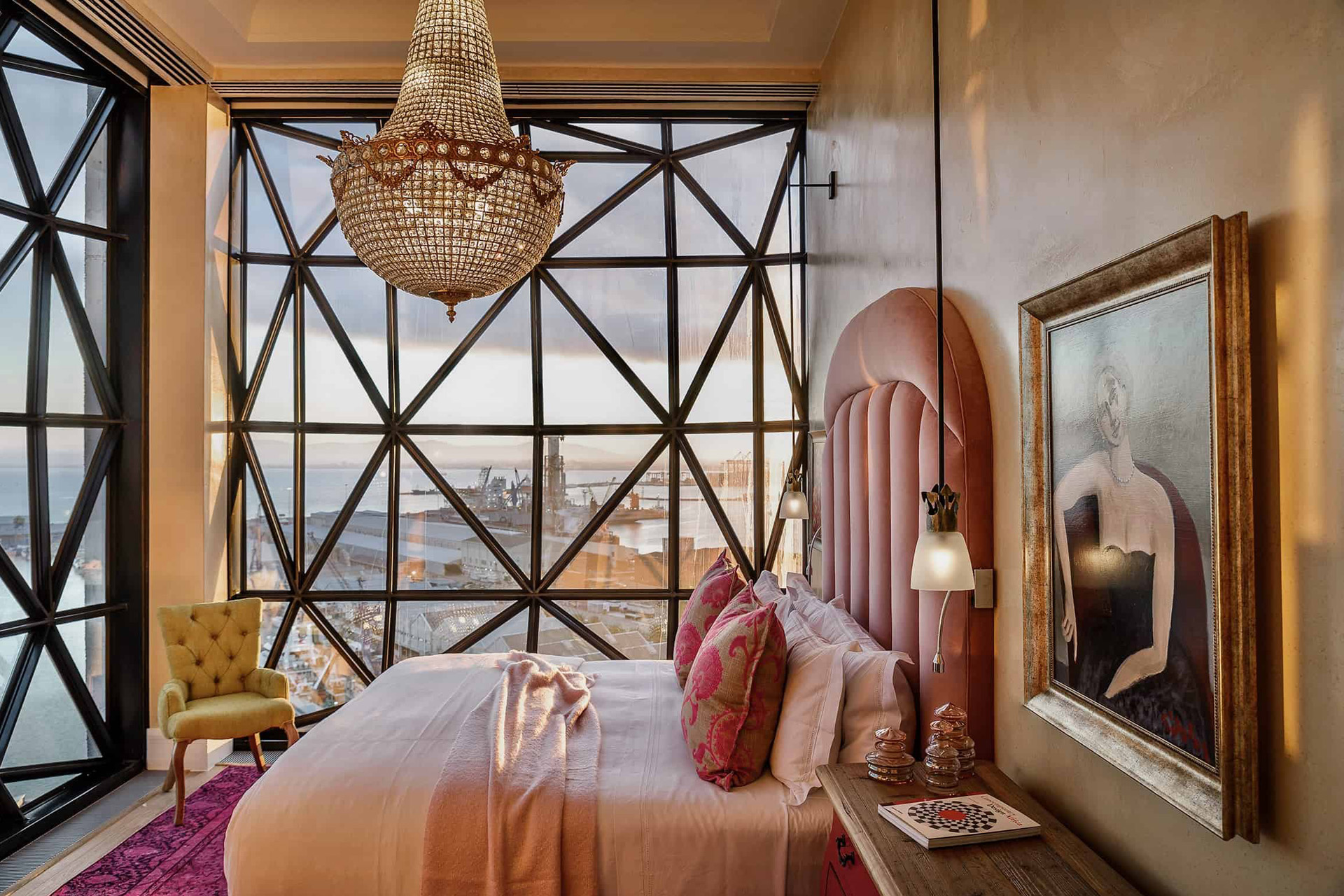 Royal Suite with geometric windows and a pink bed at The Silo