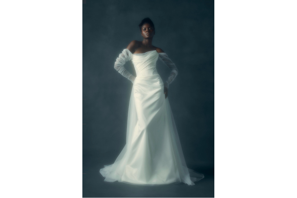 Black woman in white gown with sheer sleeves