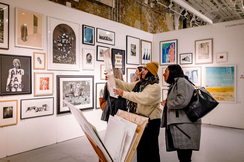People admiring art at Woolwich Contemporary Print Fair 2022