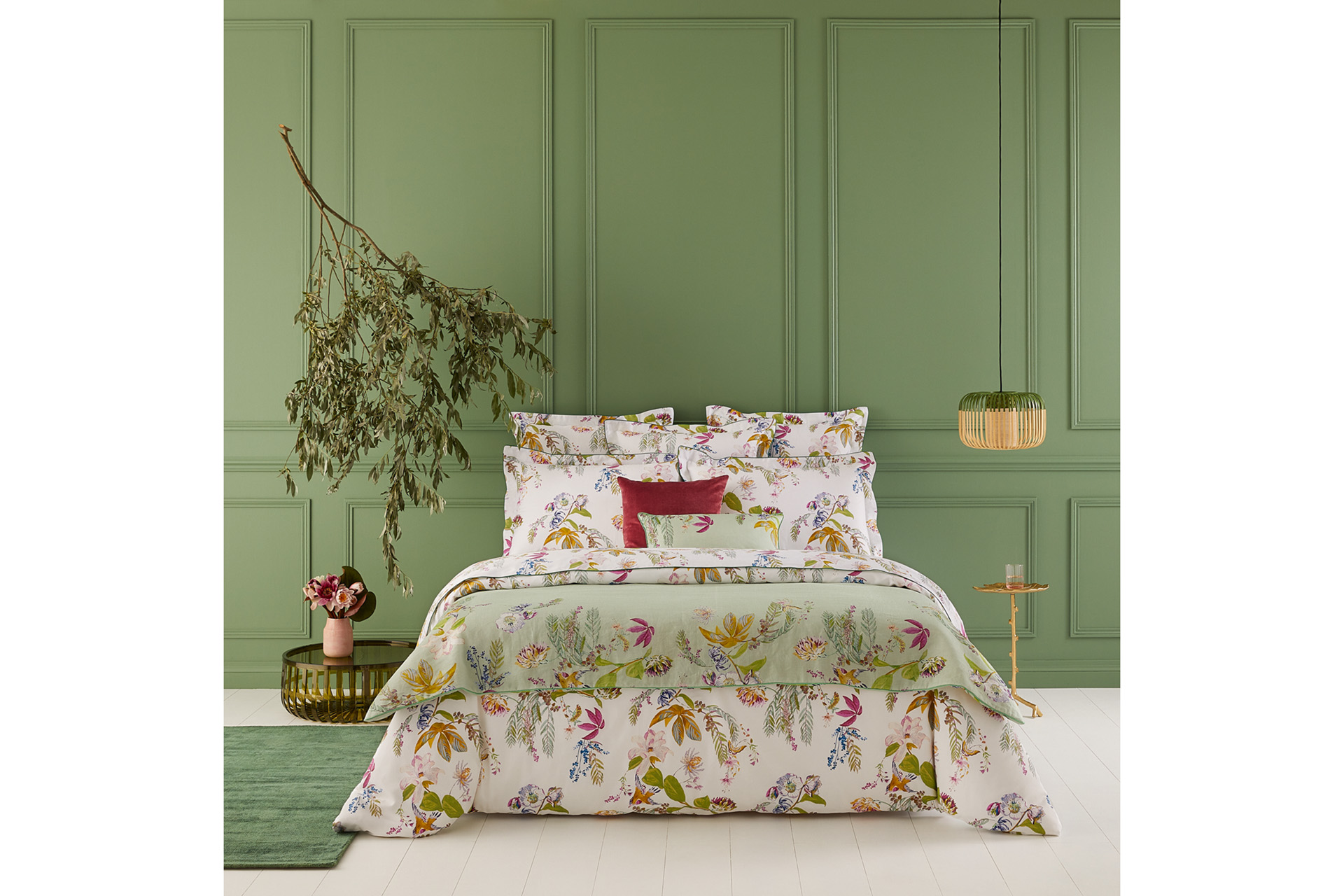 A bed with floral quilt by Yves Delorme