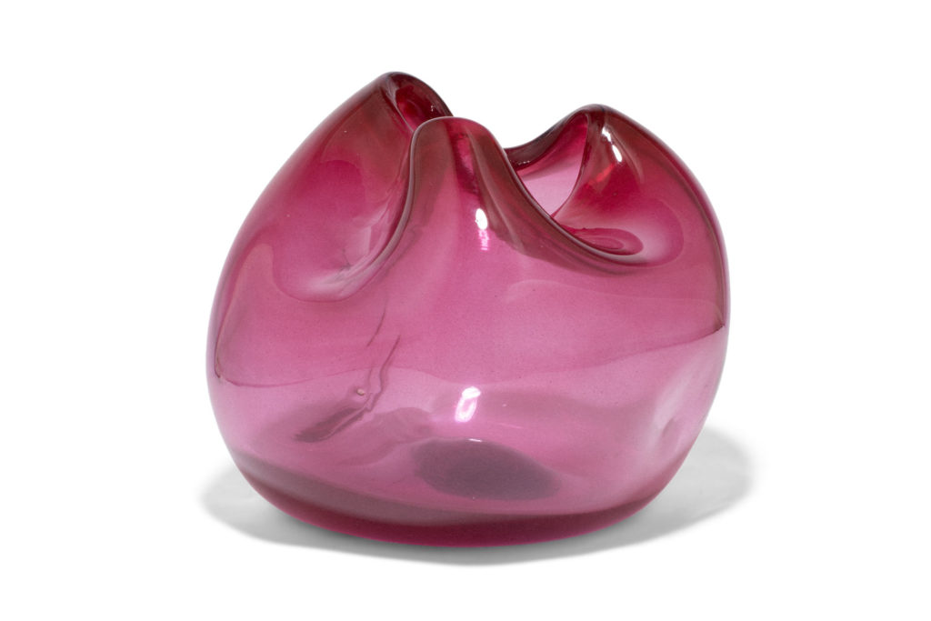 Magenta vase from Completed Works made from organically shaped recycled glass.