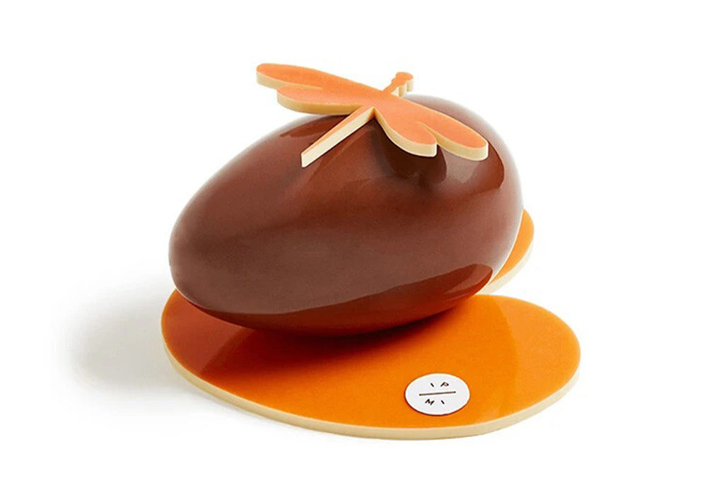 An easter egg sitting on a chocolate lily pad