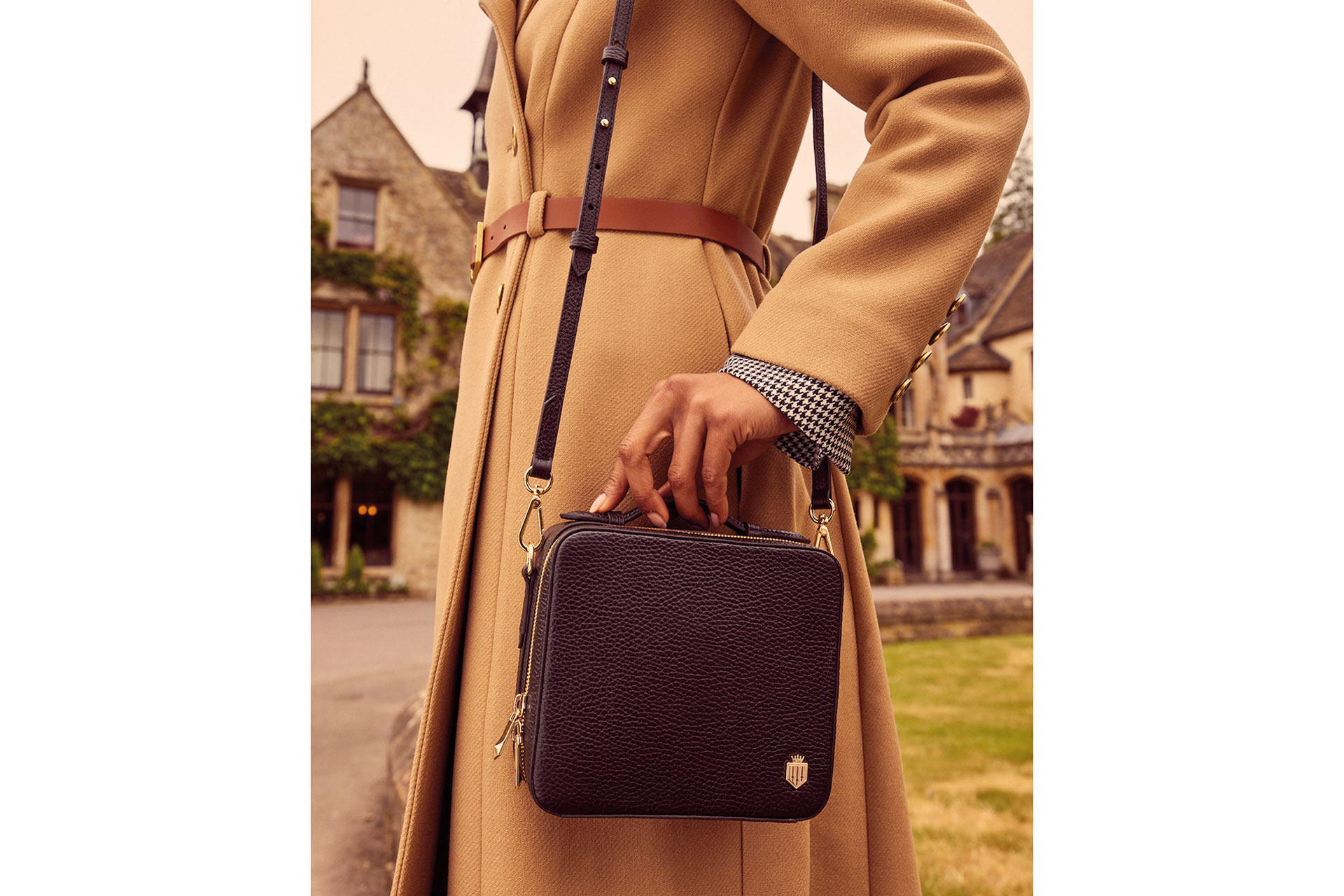 A beige coat and black bag