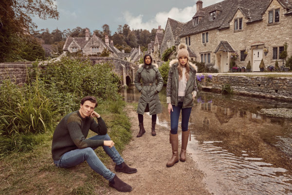 Two women and a mam standing in a country lane