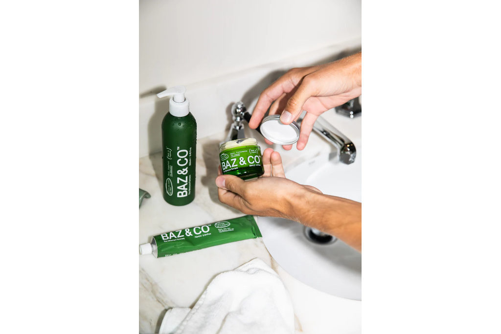 Green skincare bottles on sink