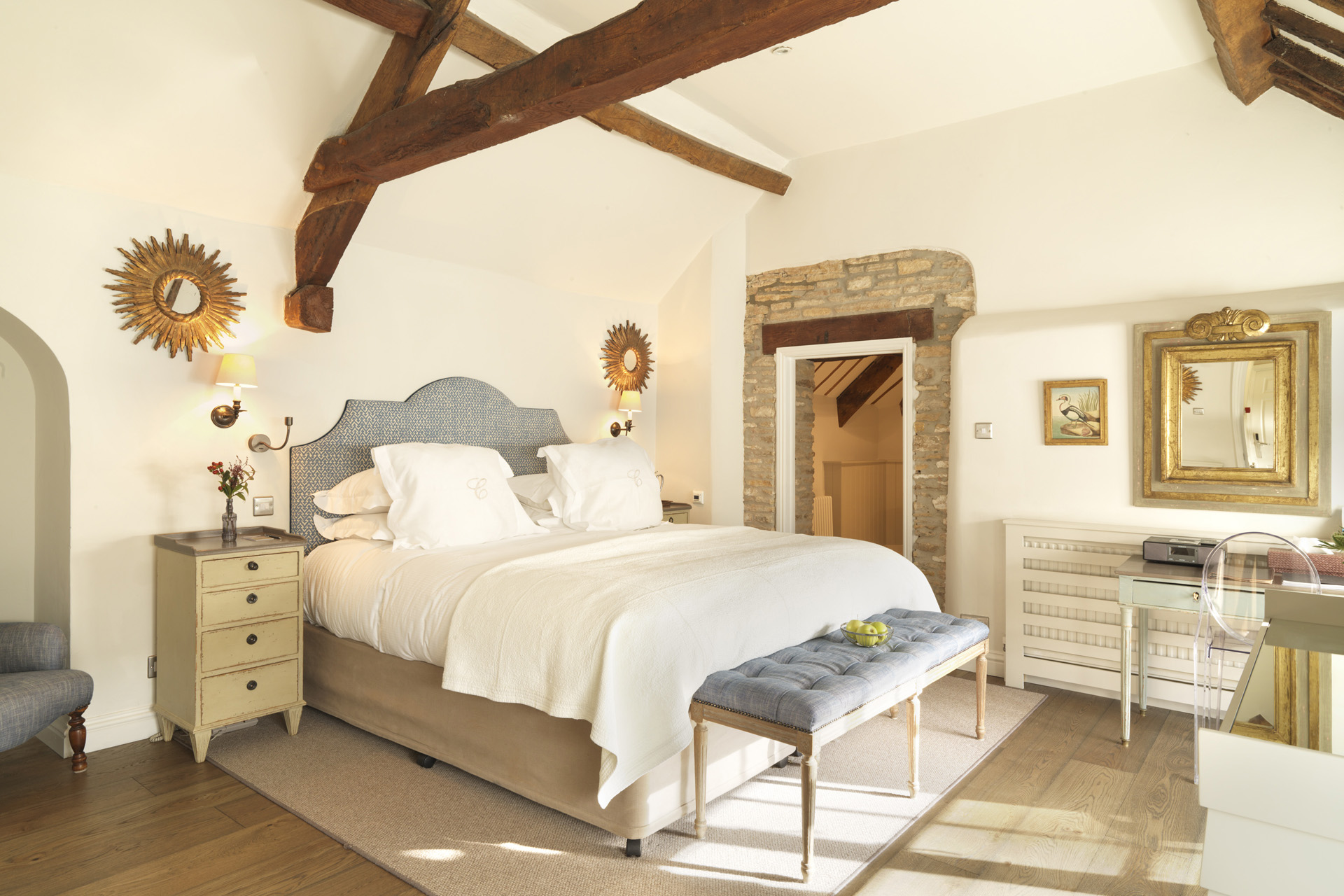 A light filled bedroom with beams