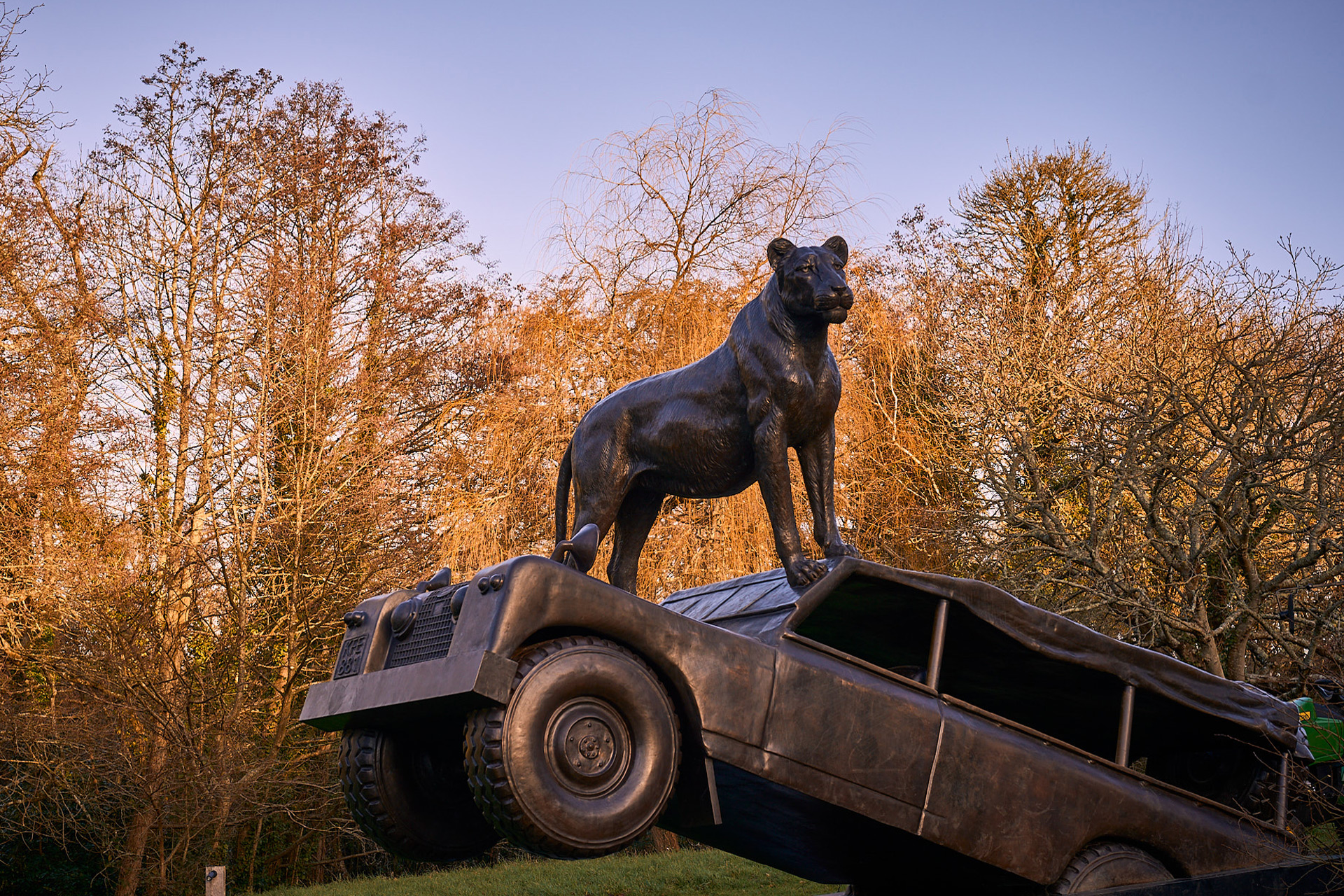 Sculpture of lion standing on the bonnet of a car.