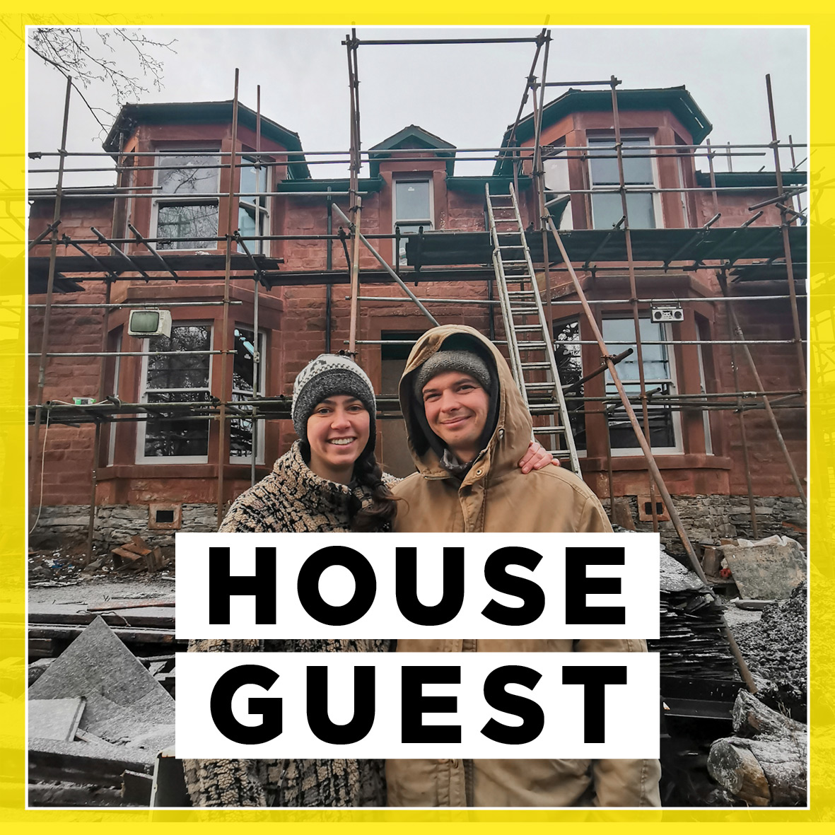 Young couple in front of partially-renovated Scottish villa.