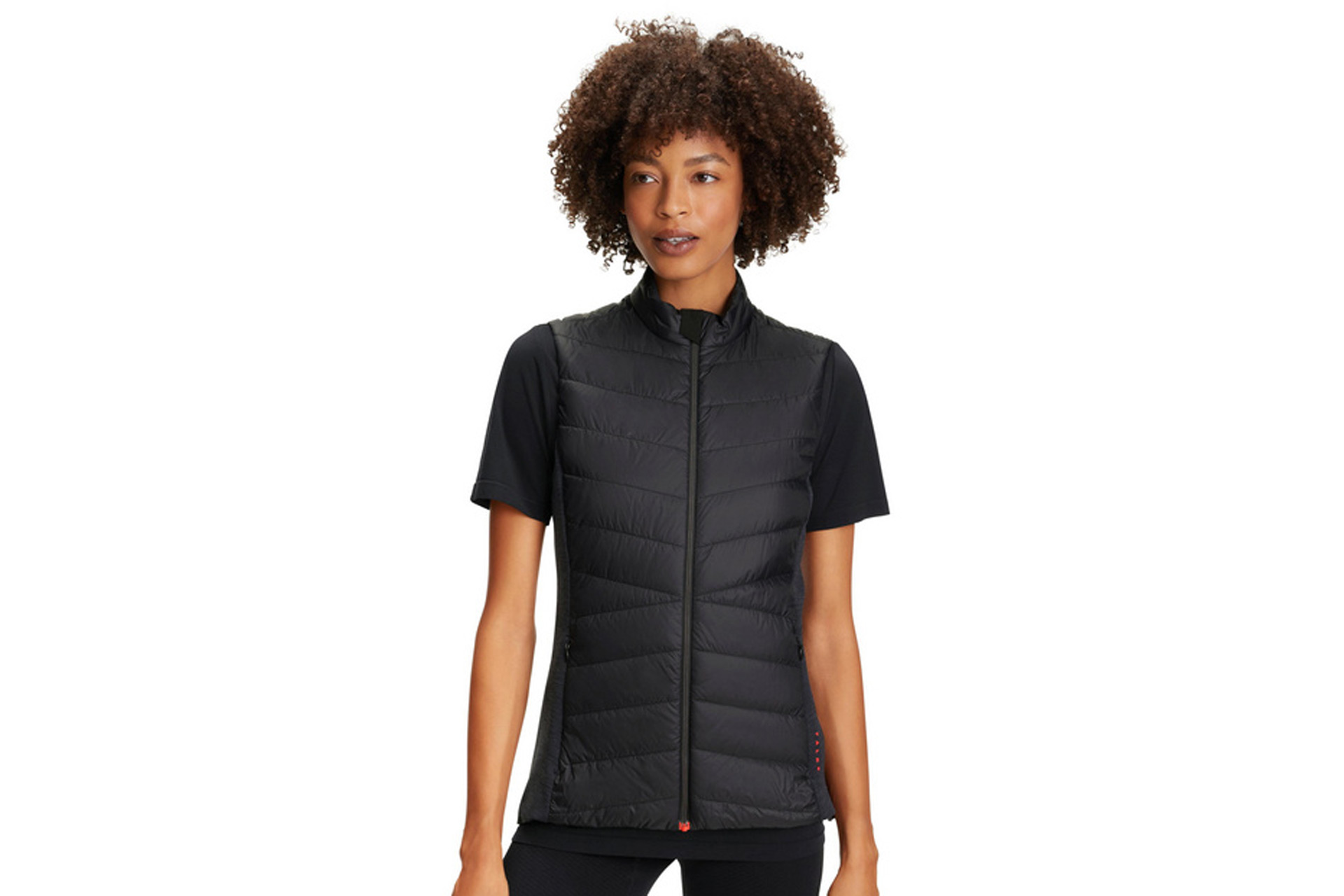 Black padded gilet worn over short-sleeved black t shirt.
