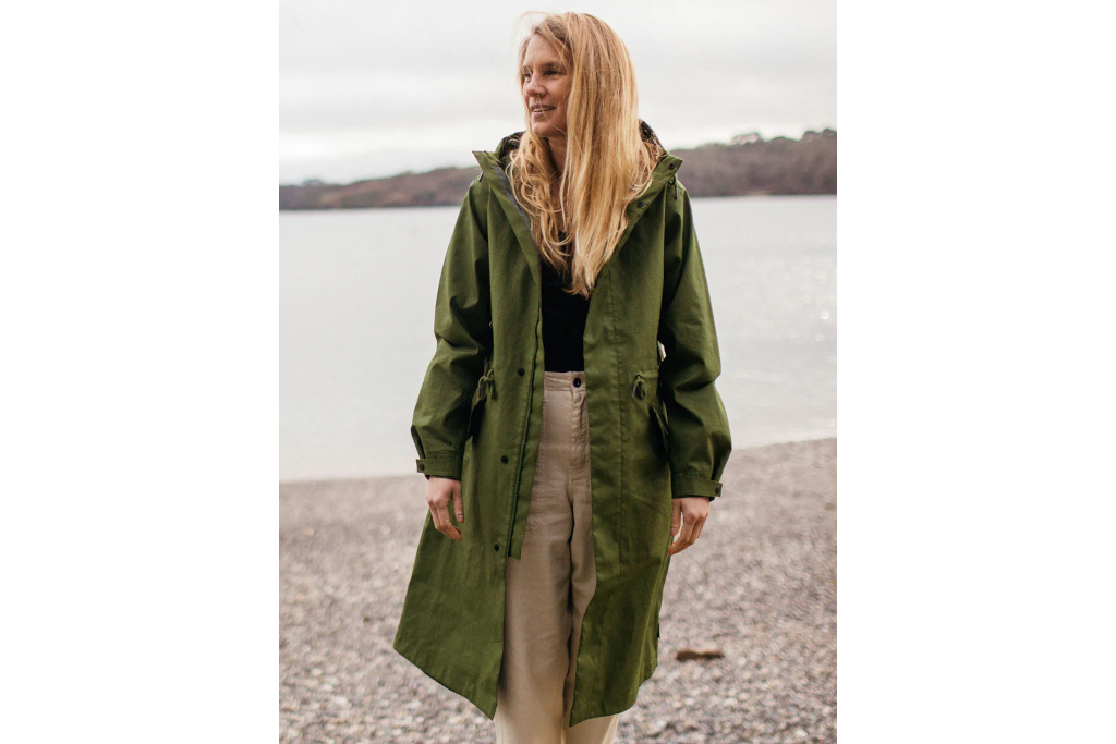 Woman on the beach wearing green coat