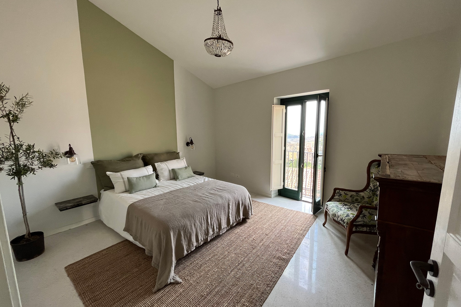 White bedroom with green feature wall