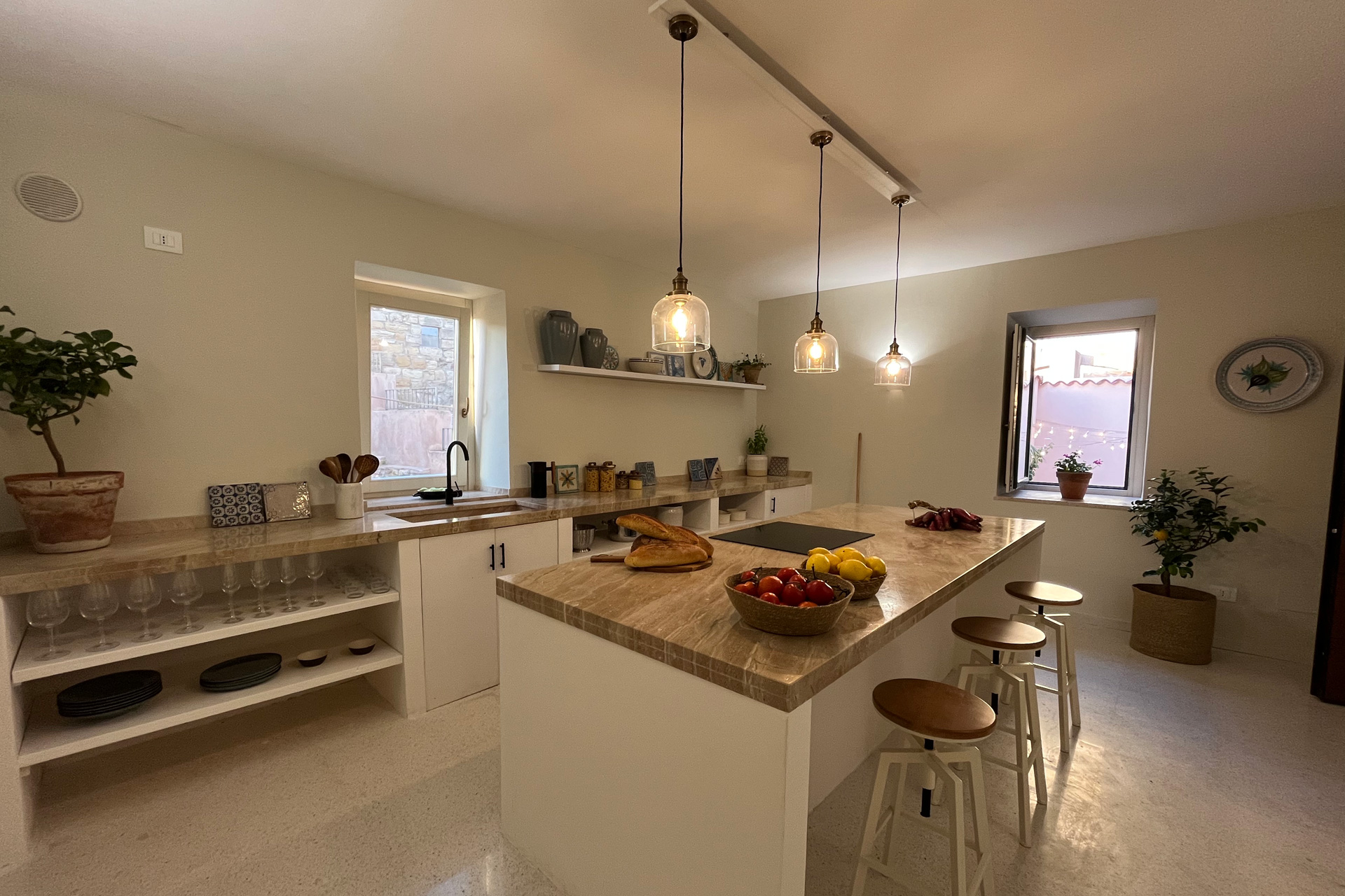 White marble kitchen with wooden bar stools