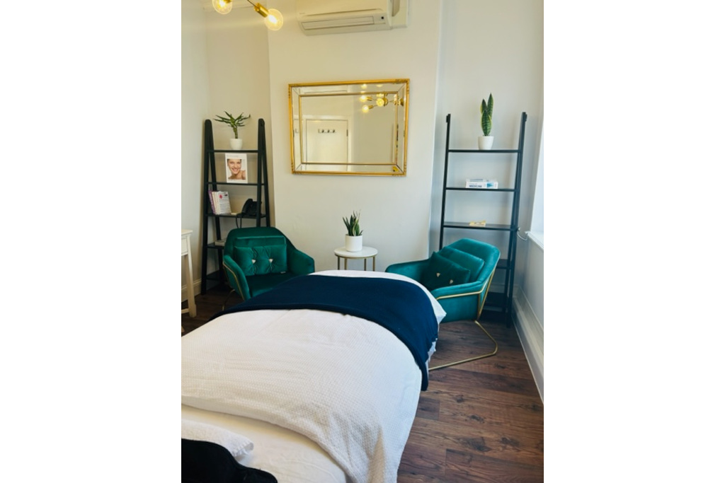 Massage table set with green armchairs around it