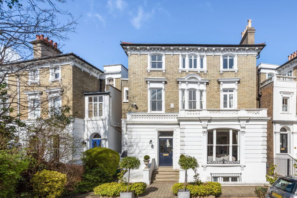 Early Victorian detached townhouse with white ground floor exterior and brick upper extension.