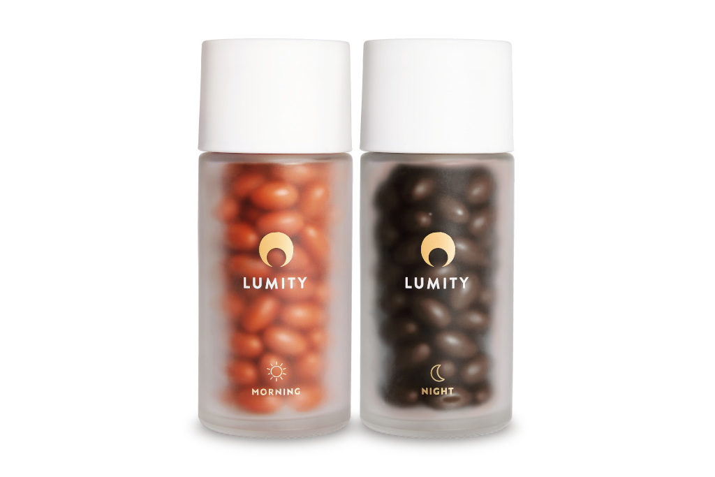 Two clear bottles with red and brown supplements inside