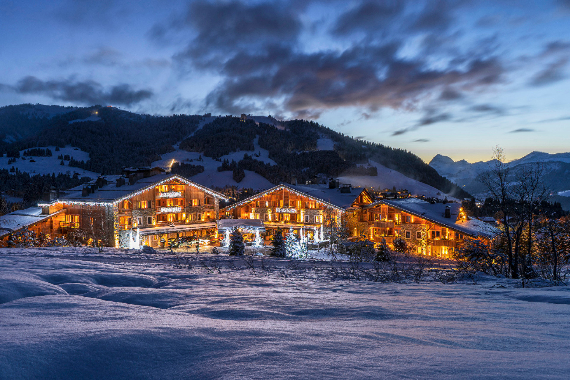 Four Seasons Hotel Megève lit up at dusk