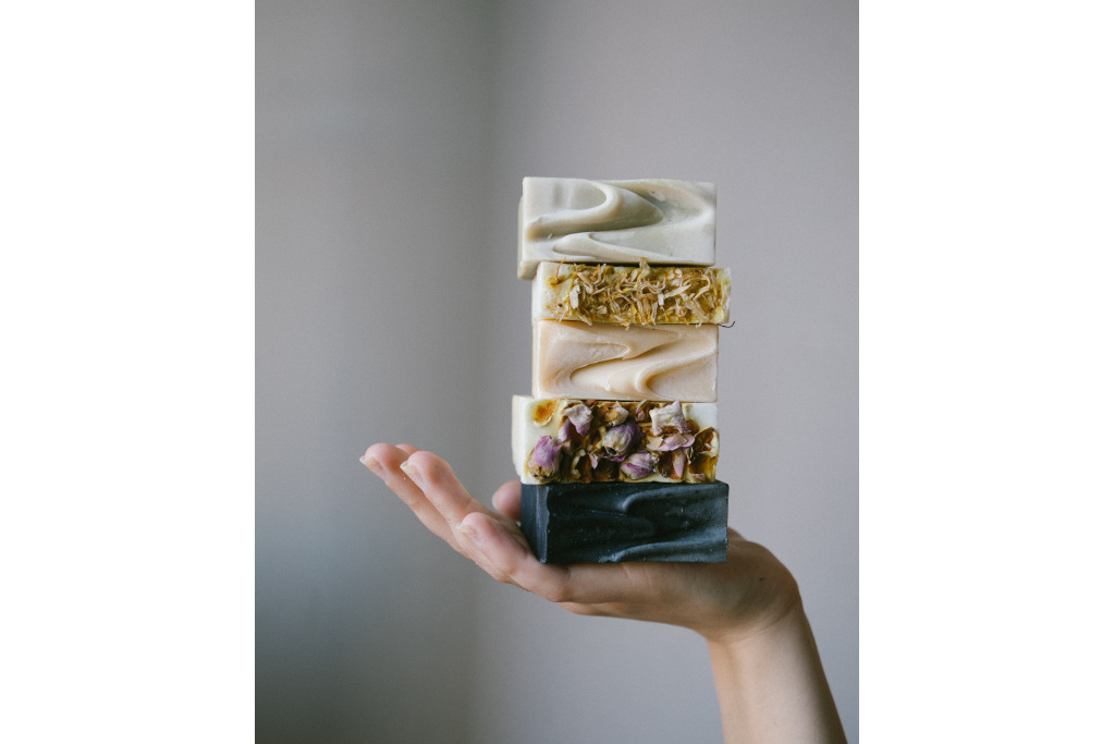 Soaps balanced on someone's hand