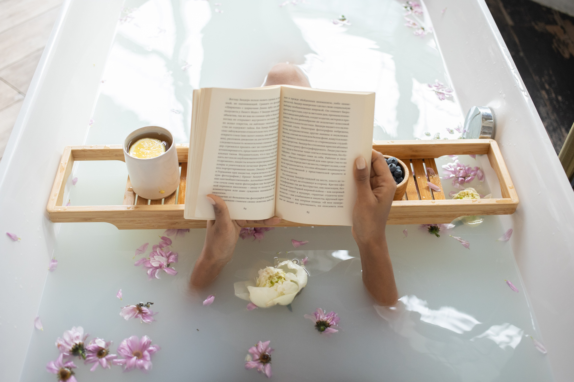 Overhead view of someone reading a book in the bath